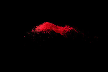 Red confetti sand falling and scatter on black space background   