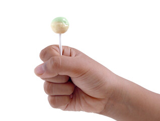 Kid hand holding green and yellow lollypop candy isolated on white background