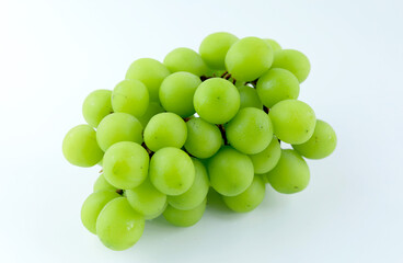 Fresh Shine Muscat grapes on a white background. Sweet green grapes