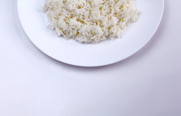 Cooked white rice on a plate and isolated on white background