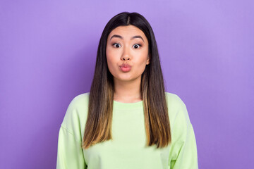 Photo of flirty sweet lady wear green sweatshirt lips pouted sending you kiss isolated purple color background