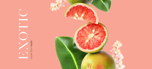 Creative layout made of grapefruit, exotic flowers and green leaves  on the pink background. Flat...