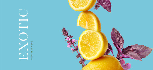 Creative layout made of yellow lemon, exotic flowers on the blue background. Flat lay. Food concept.