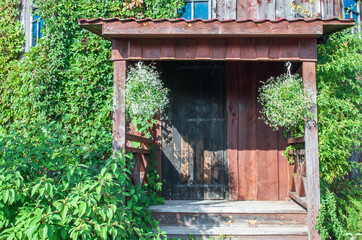 Retro wooden front door of old house. Entry to vintage wood home