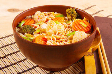 Clay bowl with vegetarian meal. Veg Noodles