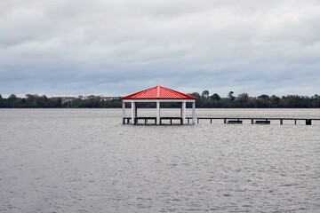 Flooded boardwalk and gazebo on a lake after a hurricane passed through