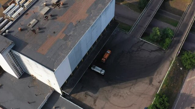 Logistics park with warehouse and several trucks. Aerial top view from drone.
