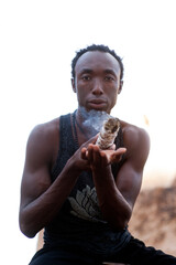 Photographs of a young black gay man practicing Reiki in the desert.  - 619525252