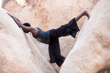 Photographs of a young black gay man practicing Reiki in the desert.  - 619525692