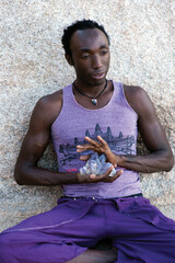 Photographs of a young black gay man practicing Reiki in the desert.  - 619526207