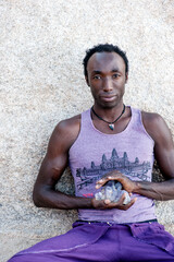 Photographs of a young black gay man practicing Reiki in the desert.  - 619526223