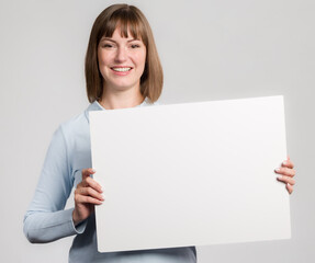 Young happy woman with an empty advertising board ready for lettering