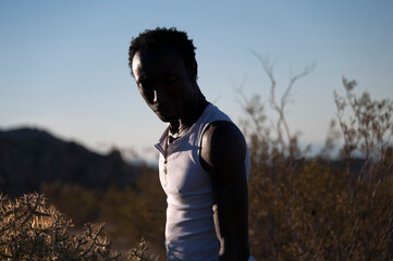 Photographs of a young black gay man practicing Reiki in the desert.  - 619528265