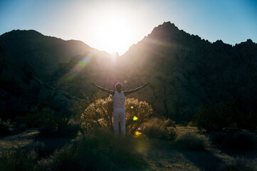 Photographs of a young black gay man practicing Reiki in the desert.  - 619528496