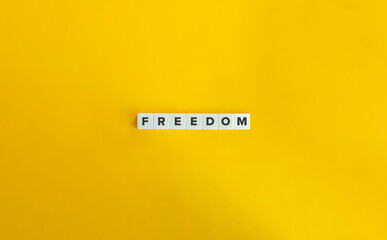 Freedom Word on Block Letter Tiles on Yellow Background. Minimal Aesthetics.