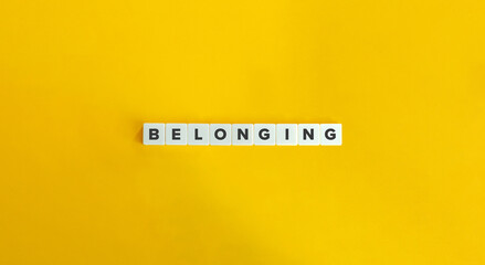 Belonging Word on Block Letter Tiles on Yellow Background. Minimal Aesthetic.