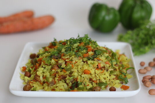 Vegetable Poha is a quick breakfast or snack made of beaten rice or flattened rice along peanuts, carrots and chilies.