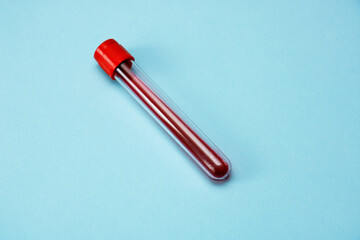 test tube with blood on a blue background
