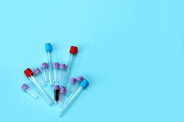 a test tube filled with blood among many empty test tubes on a blue background with copy space.