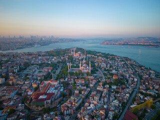 Naklejka premium Blue Mosque Sultan and Hagia Sophia aerial view at sunset with Bosphorus Strait in Sultanahmet in city of Istanbul, Turkey. Historic Areas of Istanbul is a UNESCO World Heritage Site since 1985. 