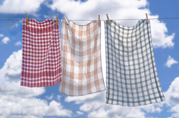 Fresh hung laundry against a blue sky and clouds.