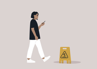 Young Caucasian character distracted by their smartphone ignoring a yellow wet floor caution sign on their way