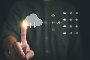 The businessman's finger points to the cloud icon, signifying the seamless connection and access to...
