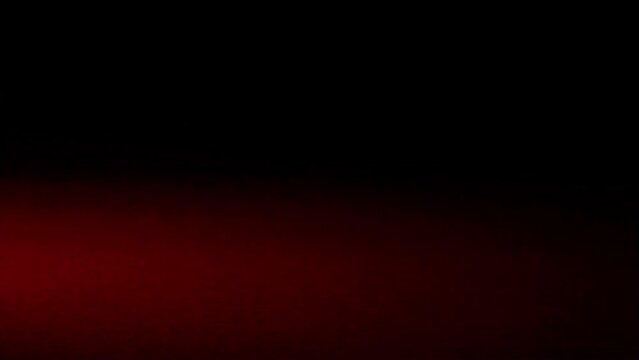 Full-screen strip of light leakage on anamorphic lens from strobe blue-red flashing lights of special services, looping video on black background for overlay effect.