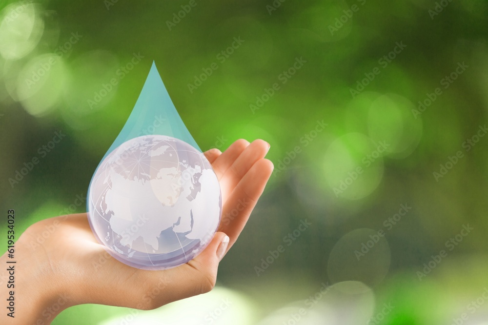 Poster Water drop in human hand on natural background