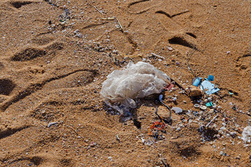 Plastic bag are left on the beach as waste polluting nature, Plastic is hard to degrade, destroy...