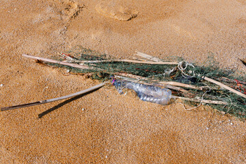 Plastic water bottles are left on the beach as waste polluting nature, Plastic is hard to degrade, destroy the ecosystem, World environment day concept.
