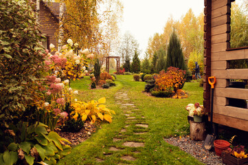 beautiful autumn garden view with curvy lawn pathway. Private natural country garden in october - Powered by Adobe