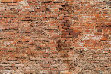 Old brick wall. The wall is red and there is mortar between the joints.