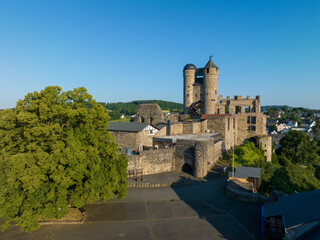 Obraz premium Renovated ruin of Greifenstein castle in Hesse, Germany. Aerial view in summer in sunrise light