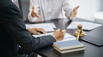 Lawyer Legal counsel presents to the client a signed contract with gavel and legal law. justice and lawyer Business partnership meeting concept.