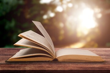 An open retro book on wooden desk