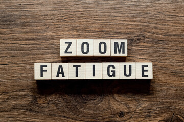 Zoom fatigue - word concept on building blocks, text
