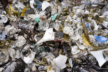 many glass shards of different colors that have partially melted