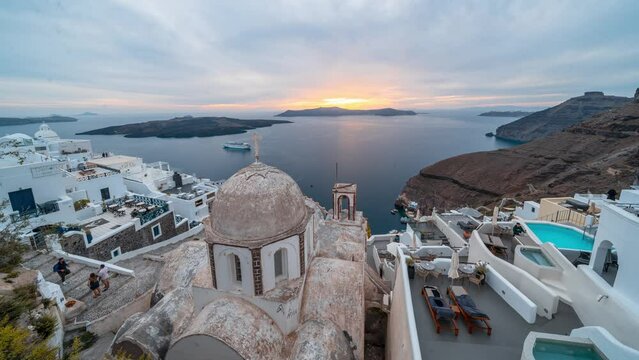 Timelapse of sunset and blue hour in Fira overlooking the St. John church and caldera on Greek island of Santorini