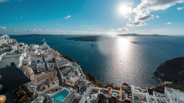 Time lapse of sunset in Fira overlooking the caldera on Greek island of Santorini with cruise ships moored in the bay