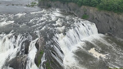 Natural wonder Cohoes Waterfall on Mohawk River in New York State with visitor overlook a...