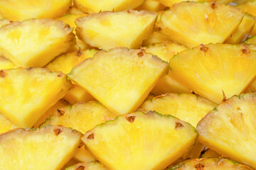 Pineapple juicy yellow slices as a background.