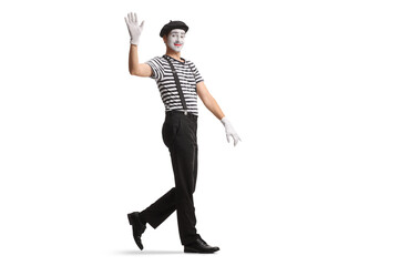 Full length shot of a mime walking and waving