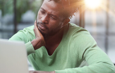 Fototapeta premium Business man in casual clothes thinking behind a laptop