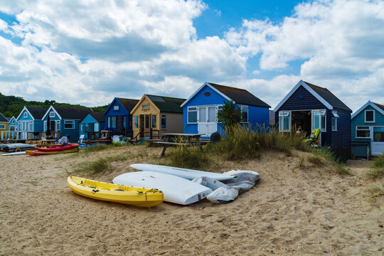 Hengistbury Head, UK - July 1st 2023: Canoe in front of Beach huts on Mudeford Sandbank.