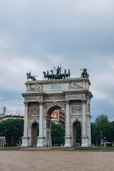 Fototapeta na wymiar Milan, Italy- May 13, 2023: Arch of Peace or Sempione Gate in Milan, near Sempione Park. Exterior view of the marble gate of the Arco della Sempione, a peace memorial in Milan. Visiting from the park.