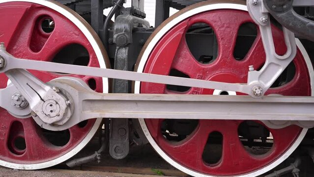 huge steel red and black wheels of an old steam locomotive