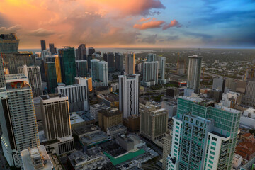 View from above of concrete and glass skyscraper buildings in downtown district of Miami Brickell in Florida, USA at sunset. American megapolis with business financial district at nightfall - obrazy, fototapety, plakaty