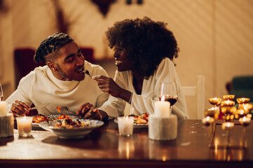 African american couple having romantic dinner date at home