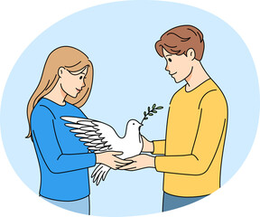 Man and woman holding dove in hands